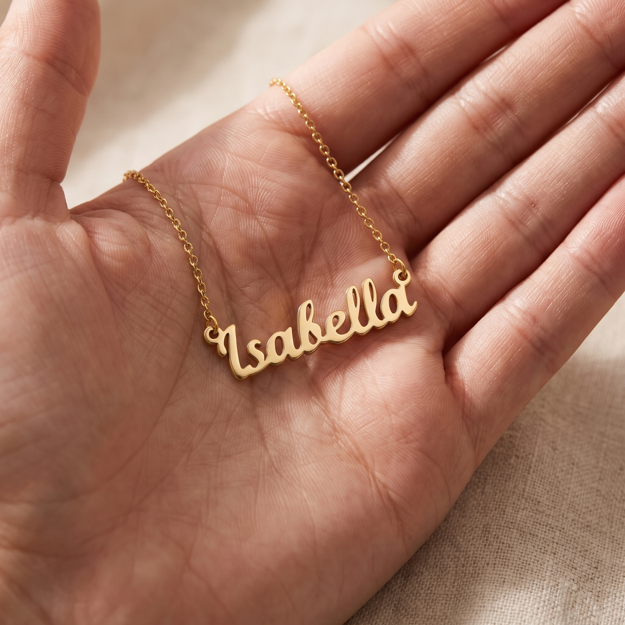 Engraved personalised pendant resting in an open palm