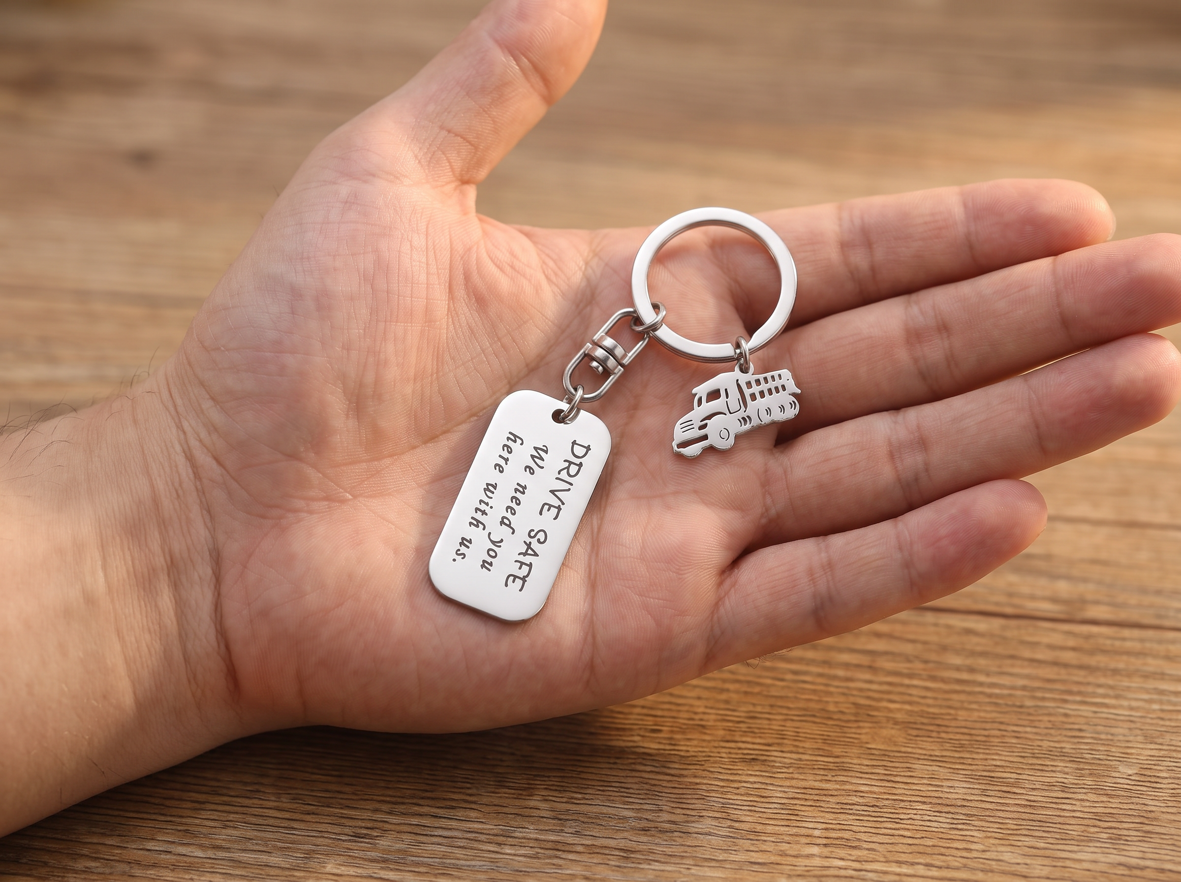 A woman giving her partner a personalised keyring wrapped for Christmas