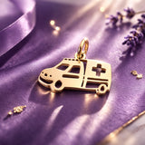 Belle Fever gold ambulance charm for keyring on purple satin, shiny paramedic vehicle charm gift for healthcare worker.