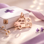 Belle Fever rose gold ambulance charm for keyring beside paramedic box, elegant healthcare appreciation gift.