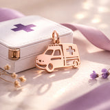 Belle Fever rose gold ambulance charm for keyring beside paramedic box, elegant healthcare appreciation gift.