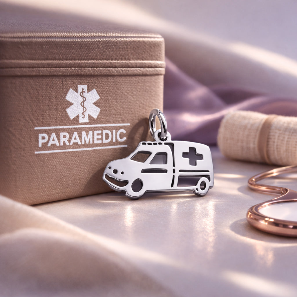 Belle Fever silver ambulance charm for keyring leaning on paramedic box, healthcare worker thank you gift.