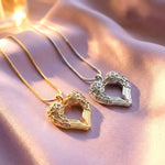 Belle Fever silver and gold angel heart necklace on purple fabric handcrafted symbolic jewellery representing love and protection