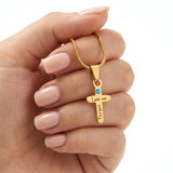 Personalized cross birthstone name necklace shown in hand, sentimental Christian keepsake by belle fever