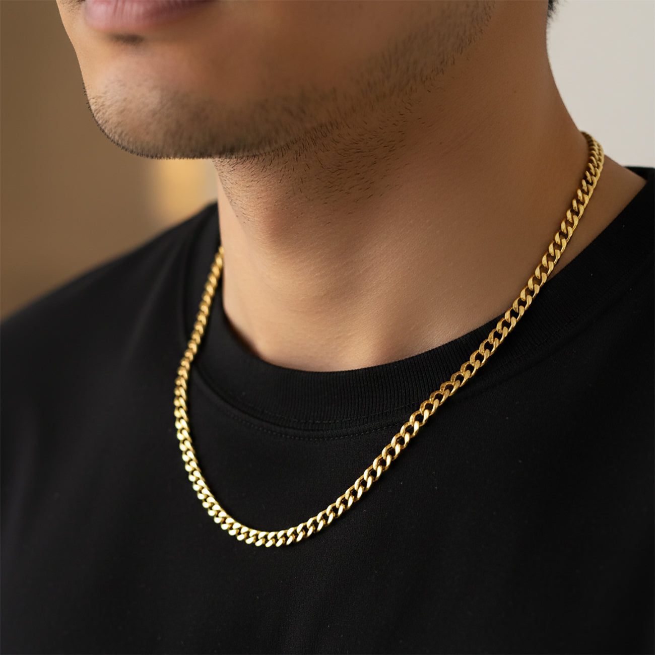 Gold curb chain necklace worn by man, waterproof non-tarnish unisex chain with bold timeless appeal.