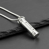 Silver Belle Fever Cylinder Cremation Necklace resting on black leather — a sleek memorial pendant keeping loved ones forever close to your heart.
