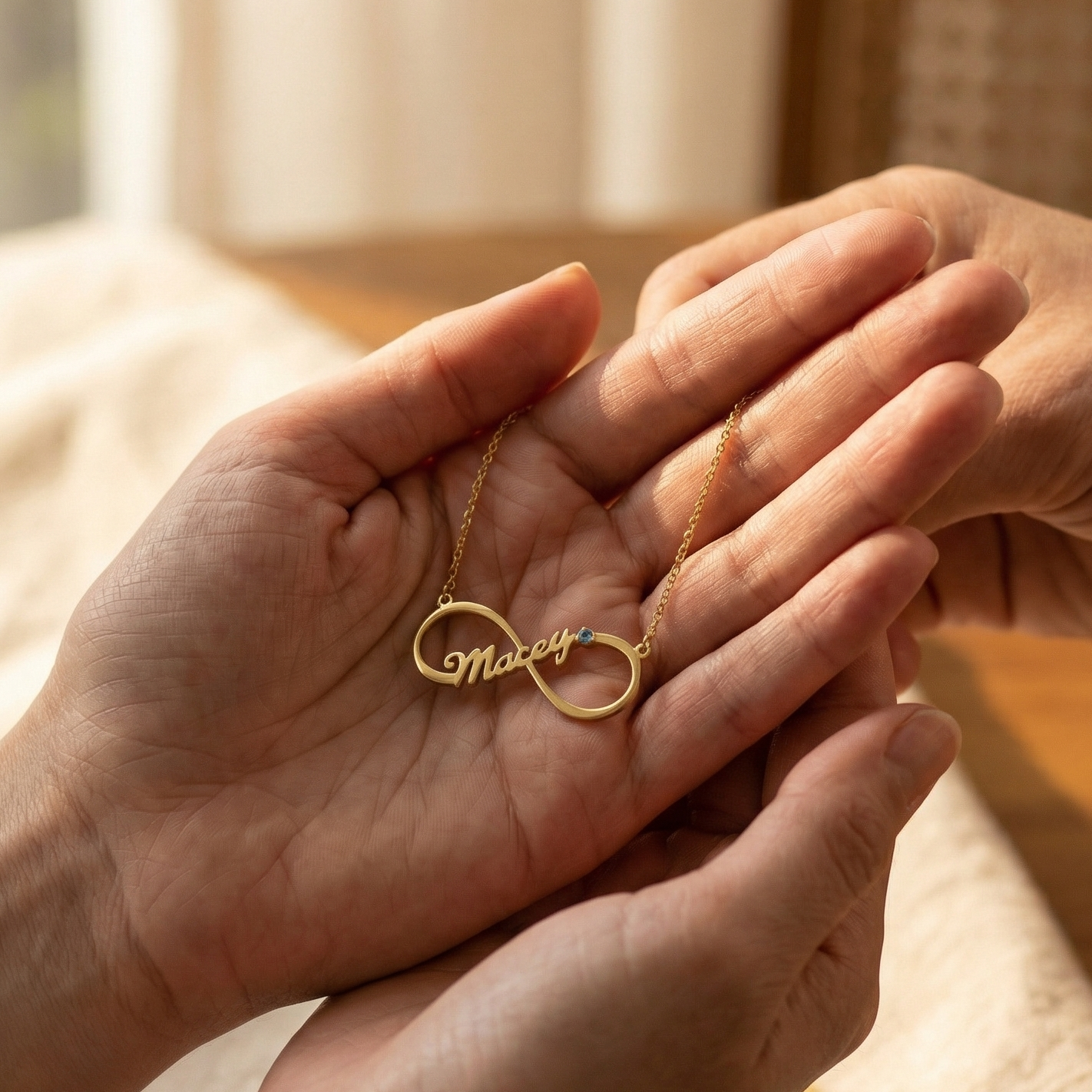 Two hands holding a gold necklace with 'Married' engraved on it, against a blurred indoor background.