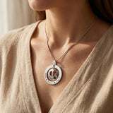 Woman wearing infinity dome necklace, meaningful jewellery symbolising eternal love and family connection