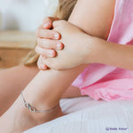 Belle Fever Infinity Anklet — elegant gold infinity charm worn at the ankle, representing enduring love and effortless beauty.