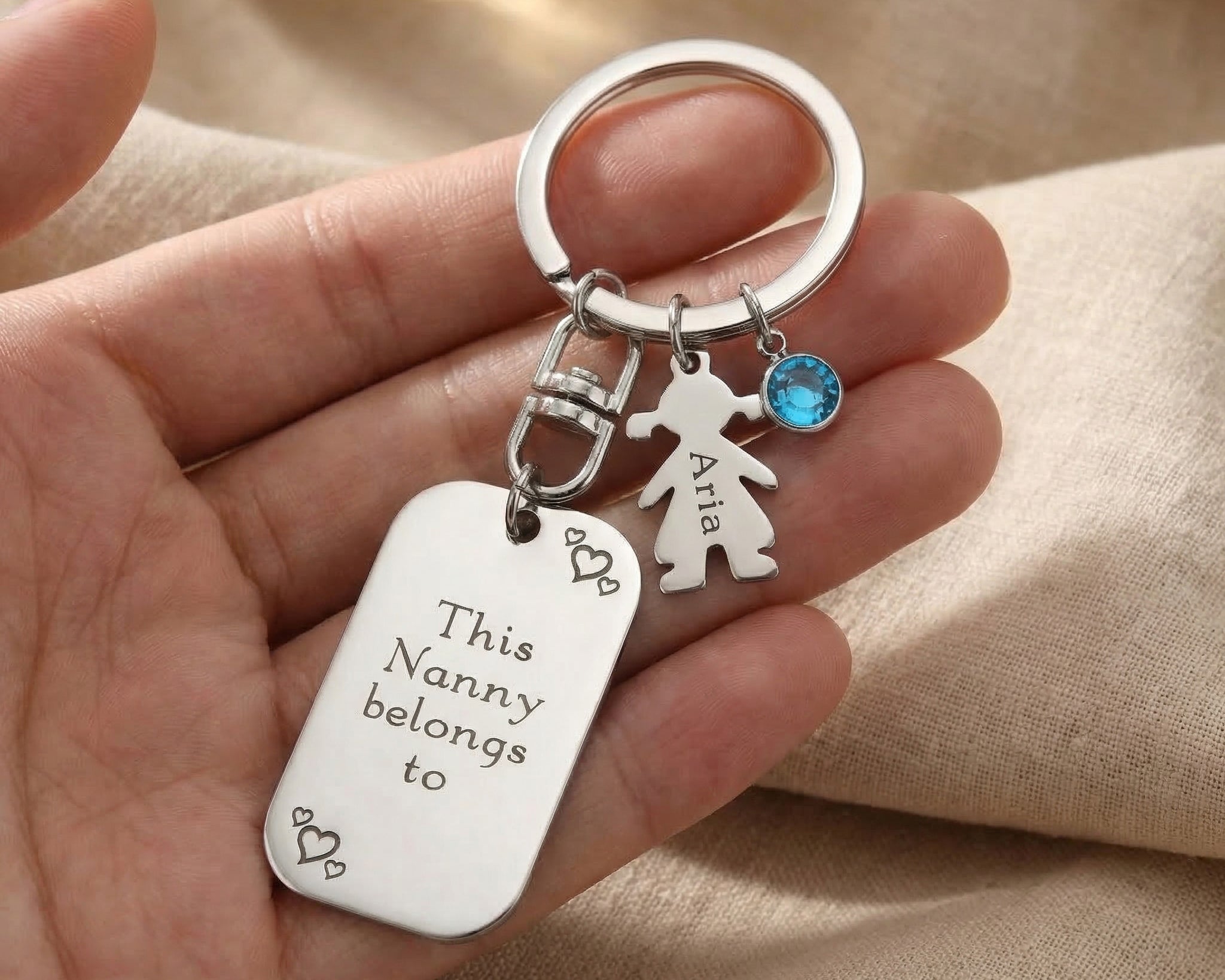 Kids Love Heart Keyring held in hand with engraved heart disc and child charm, personalised keepsake gift