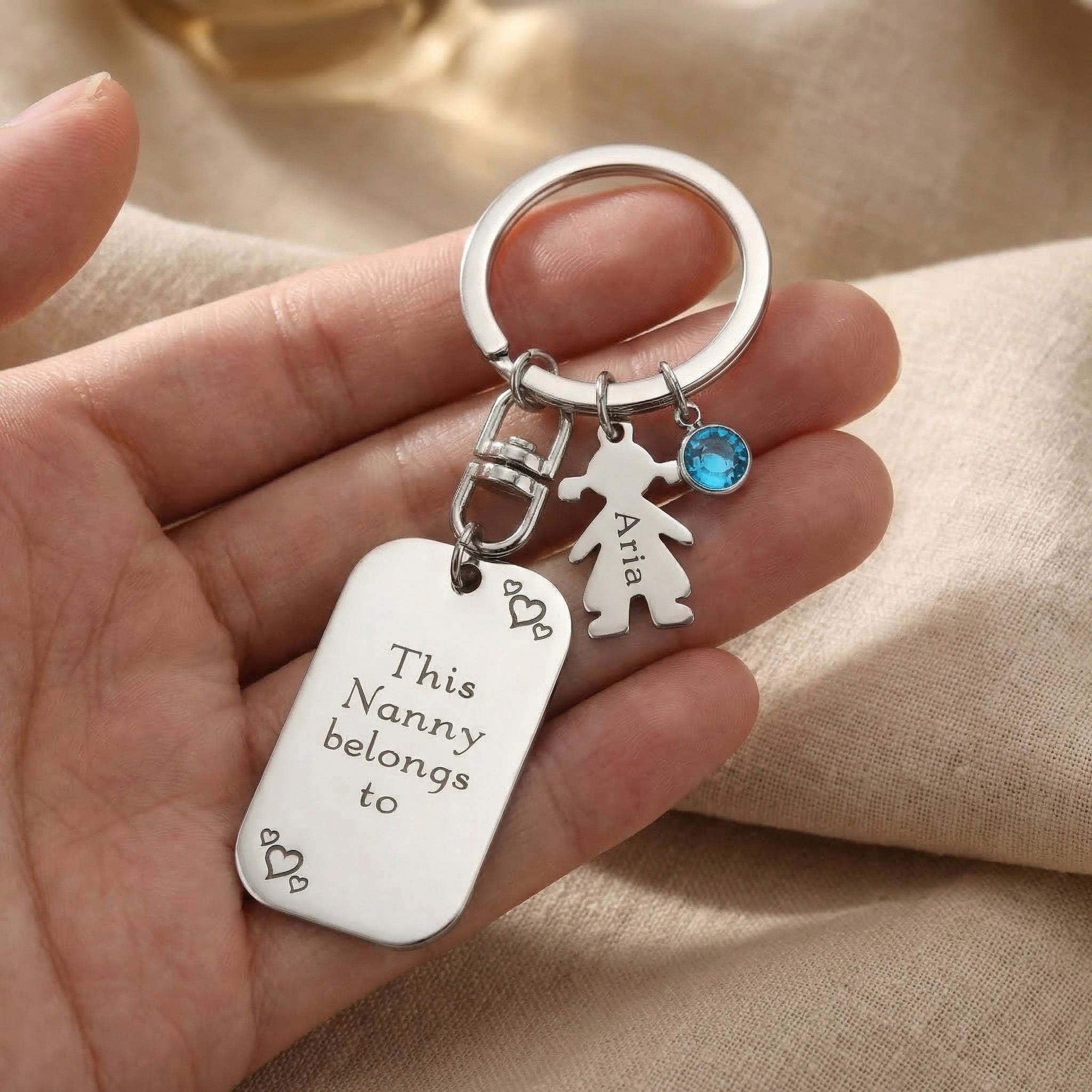 Kids Love Heart Keyring held in hand with engraved heart disc and child charm, personalised keepsake gift