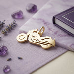 Belle Fever gold motorbike charm for keyring on lavender flat lay, shiny motorcycle charm gift for biker lovers.
