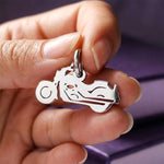 Belle Fever silver motorbike charm for keyring held between fingers, shiny biker charm gift.