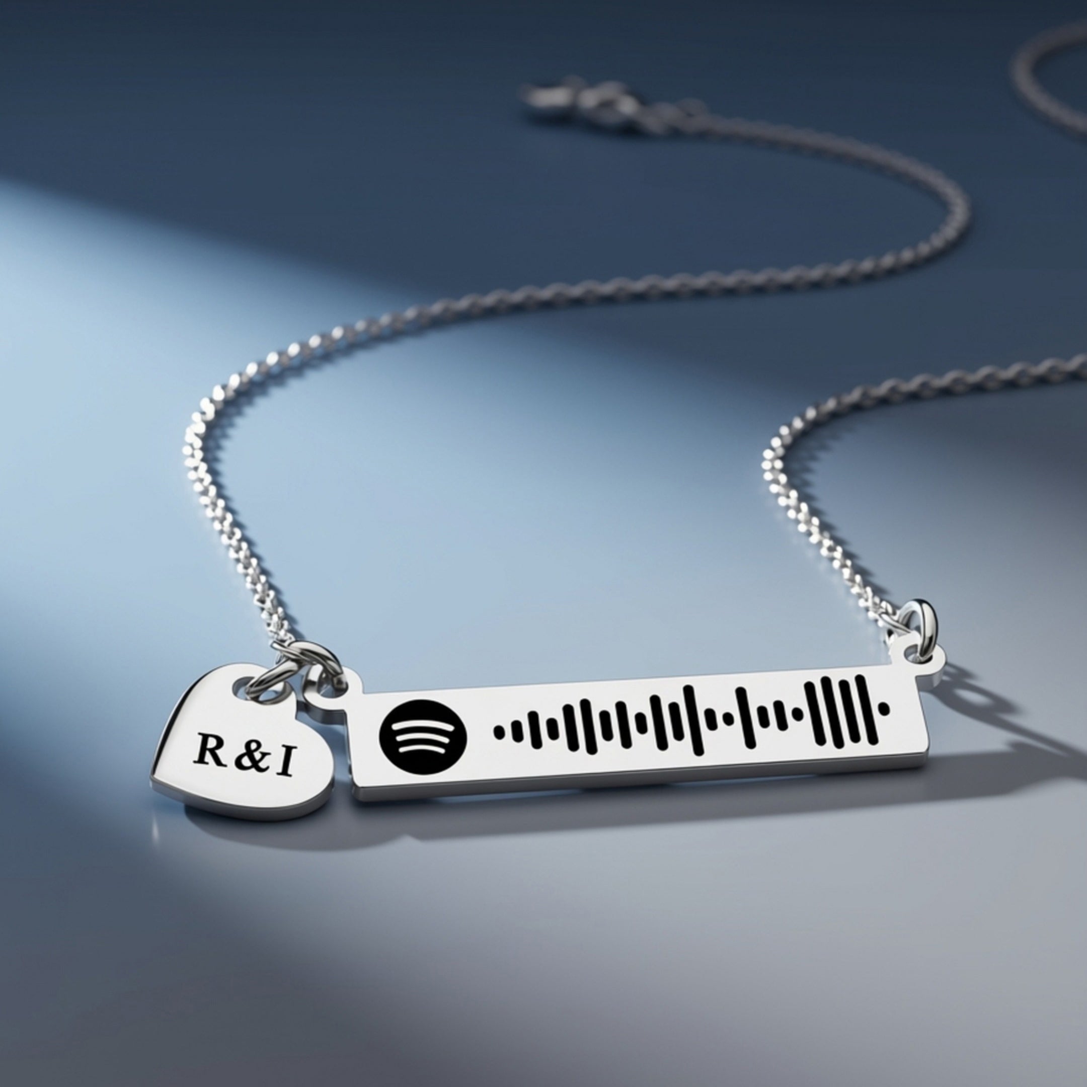 Personalized music bar necklace with engraved song code and heart charm displayed on a dark background, Belle Fever