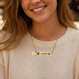 Model wearing a personalized bar necklace with engraved song code and heart charm by Belle Fever