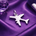 Belle Fever silver plane charm for keyring on purple satin, minimalist travel airplane charm.