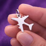 Belle Fever silver plane charm for keyring held in hand, polished stainless steel travel airplane charm