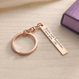 Belle Fever rose gold engraved reminder tag keychain resting on desk, custom bar keepsake gift designed for daily use