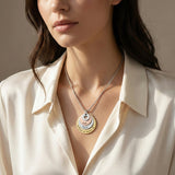 Model wearing the Tower of Love necklace with layered round charms, elegant everyday styling, design by Belle Fever 