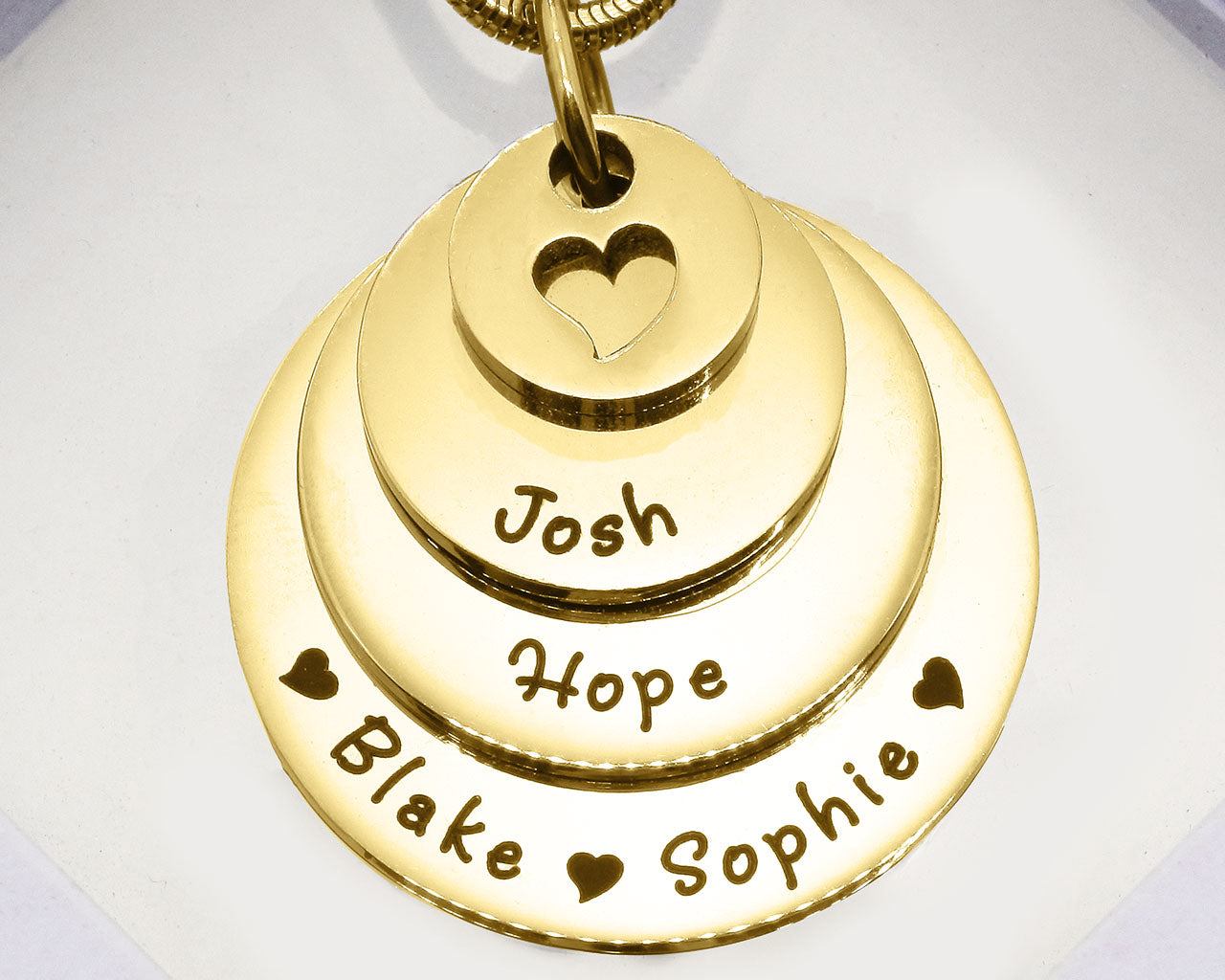 Gold Tower of Love necklace displayed on a white background, layered charm pendant detail by Belle Fever