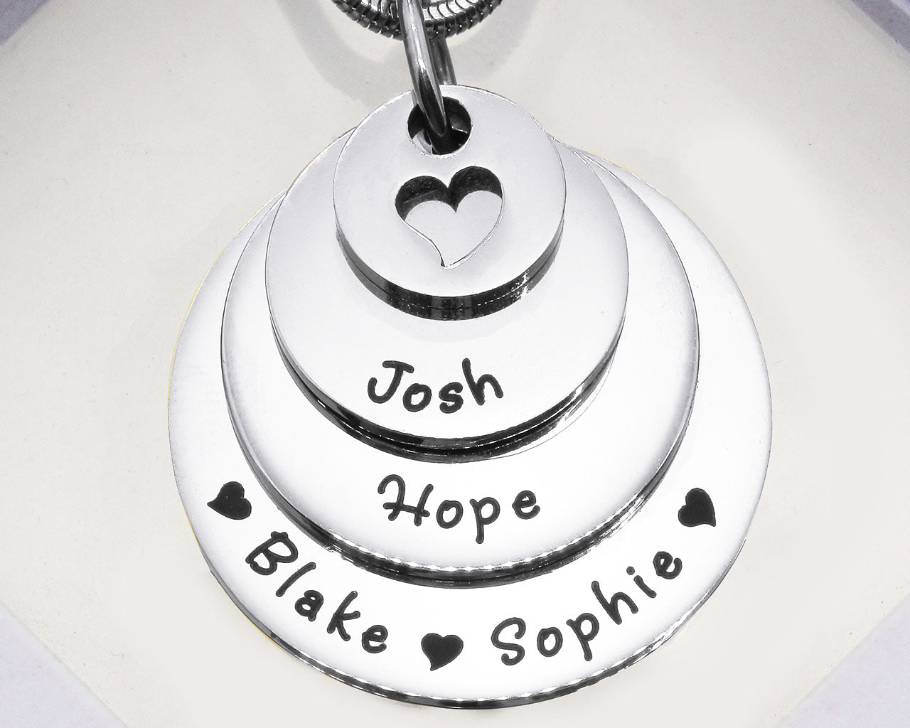 Silver Tower of Love necklace displayed on a white background, layered charm pendant detail by Belle Fever
