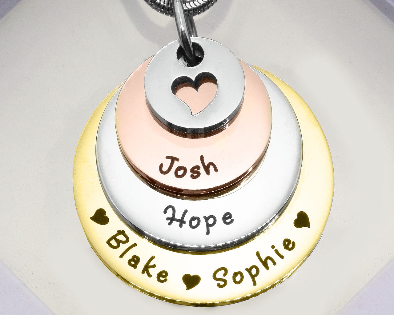 Three Tone Tower of Love necklace displayed on a white background, layered charm pendant detail by Belle Fever
