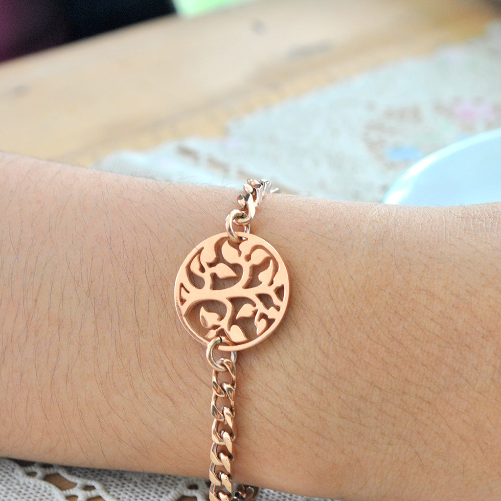 Belle Fever Tree bracelet worn on wrist, rose gold chain charm jewelry.