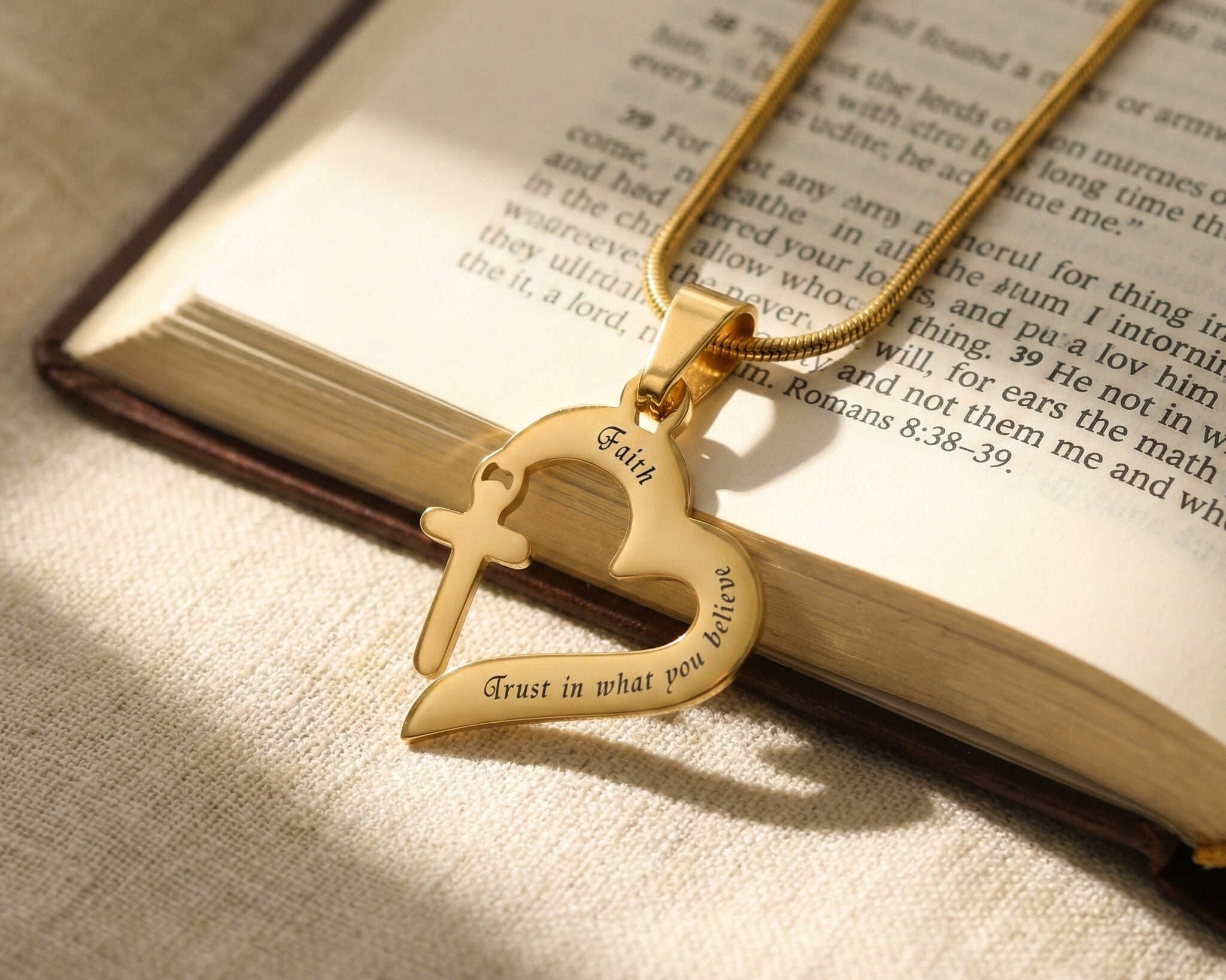 Trust in Him necklace by belle fever styled on book, inspirational Christian necklace with cross heart pendant