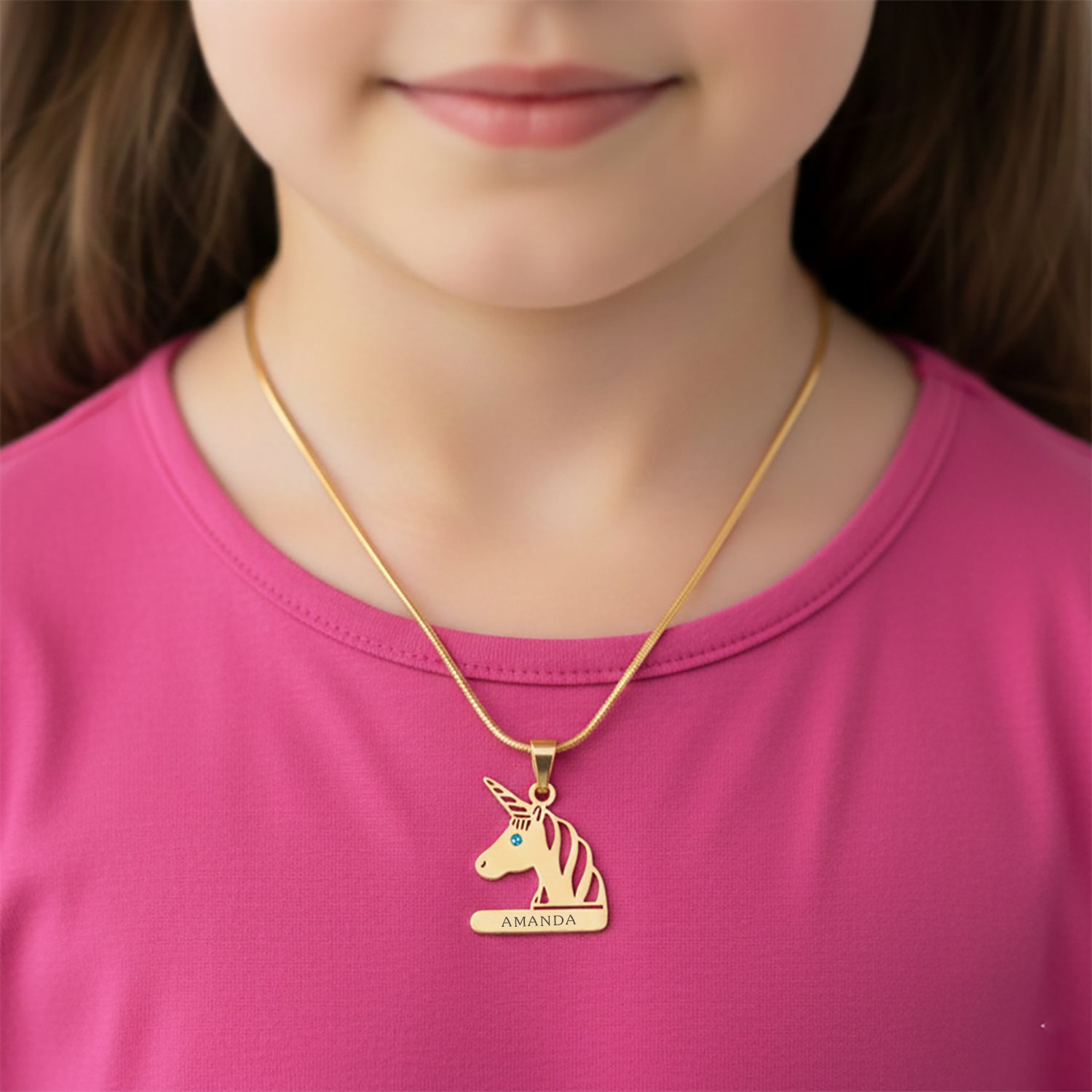 Custom unicorn head necklace with birthstone pendant worn around the neck.