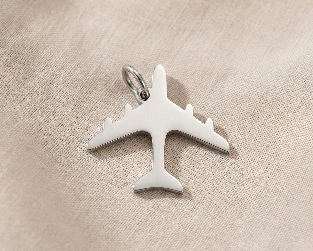 Silver airplane charm for keyring symbolizing travel memories, adventure, and meaningful journey keepsakes