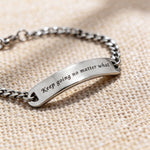 Silver bar bracelet featuring engraved plate detail