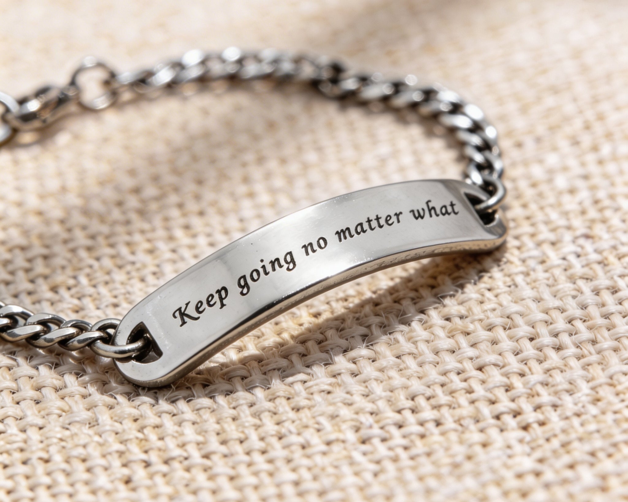 Silver bar bracelet featuring engraved plate detail