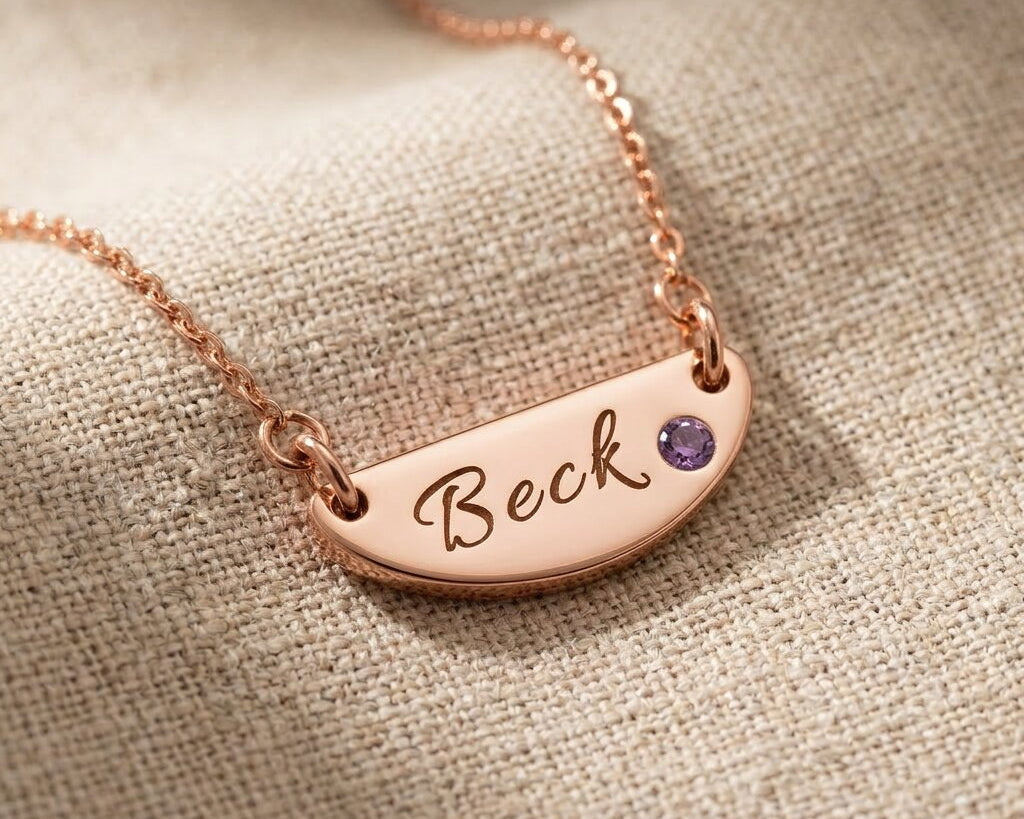 Rose gold Beck name necklace with engraved bar pendant and birthstone detail