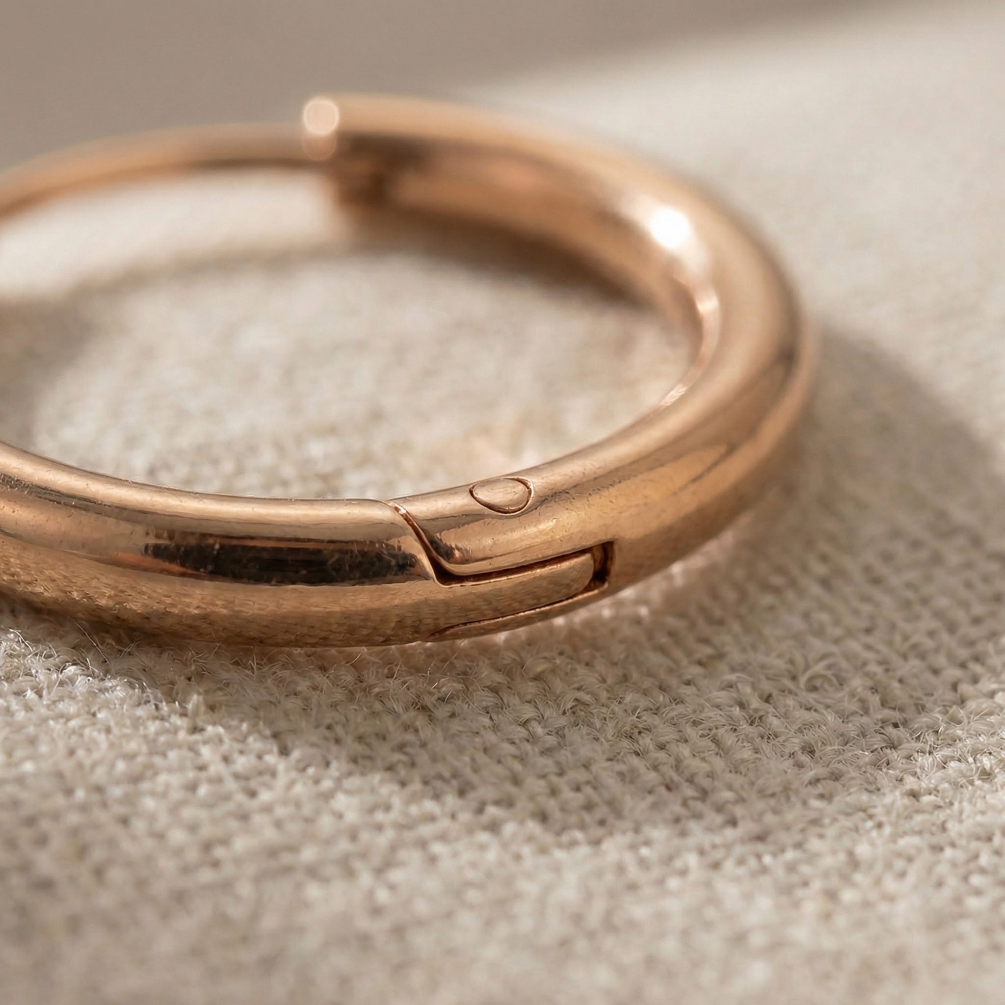 Close up of chic sleeper hoop earrings showing smooth polished hoop detail