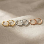 Chic sleeper hoop earrings in gold, silver and rose gold finishes with minimal hoop design