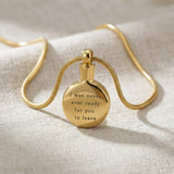 Gold circle cremation necklace with round urn pendant displayed on neutral background