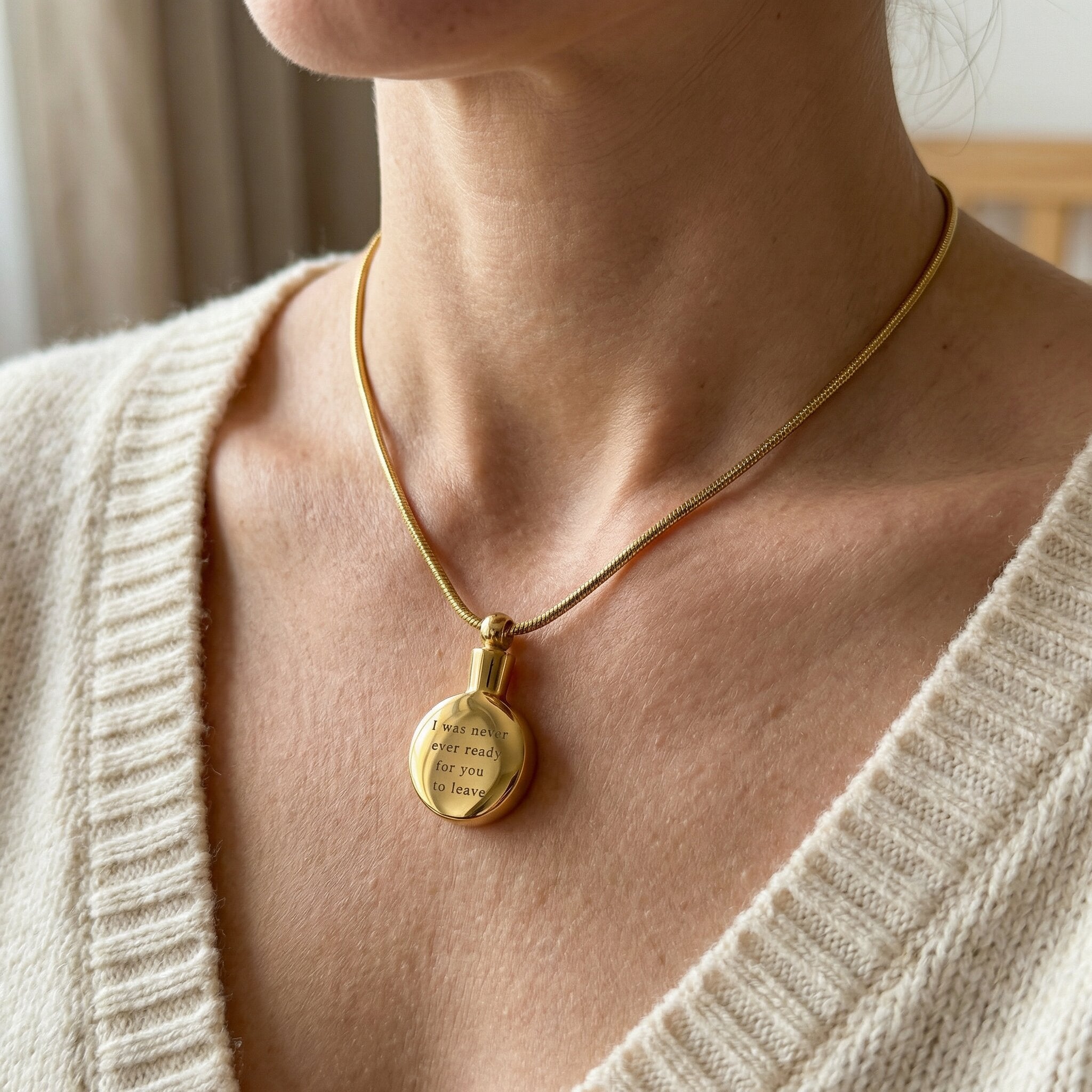 Woman wearing circle cremation necklace with round urn pendant on delicate chain