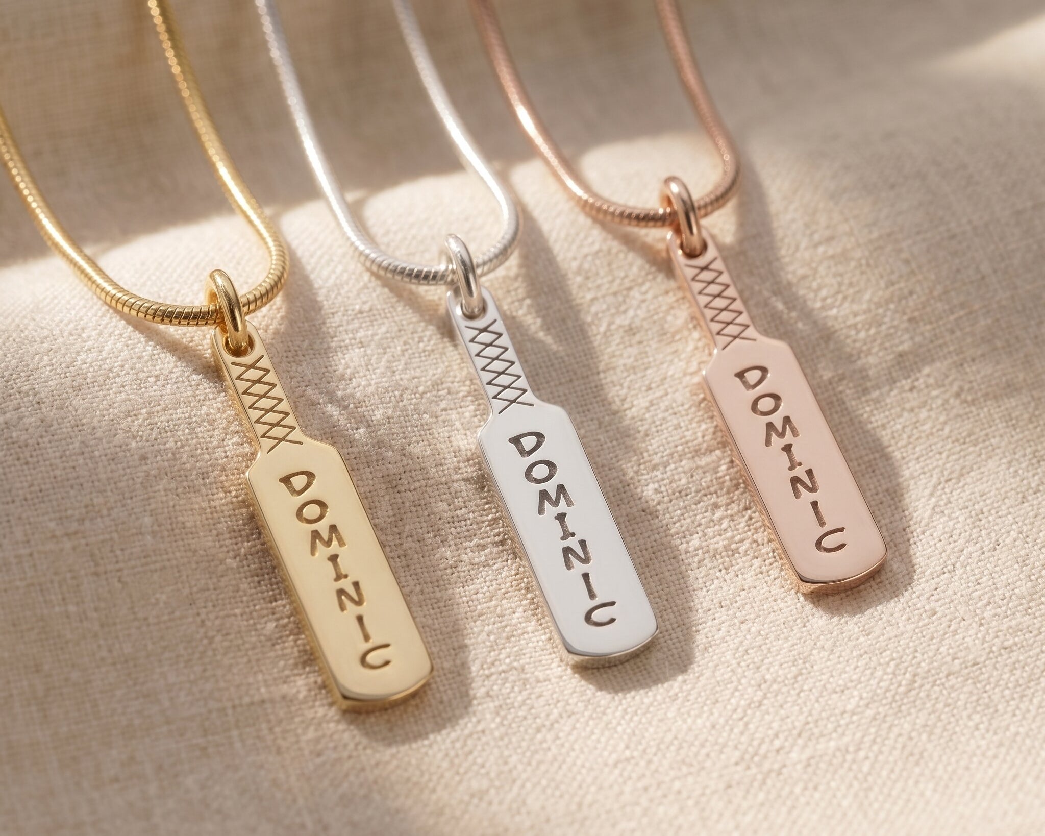 Cricket bat name necklace tone comparison showing gold, silver and rose gold finishes