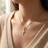 Woman wearing cross name necklace with engraved cross pendant on delicate chain