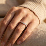 Woman wearing crystal wish ring, delicate curved band ring styled as everyday jewellery