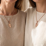 Couple wearing Double Heart Puzzle Necklace set with matching heart pendants, meaningful relationship jewellery