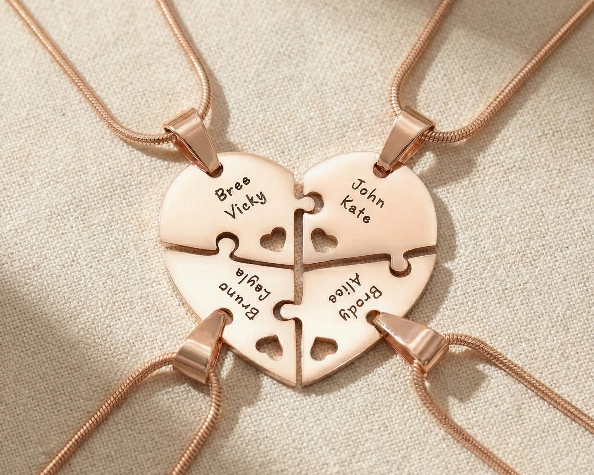 Heart Puzzle Necklace in rose gold with four interlocking engraved pieces forming heart design