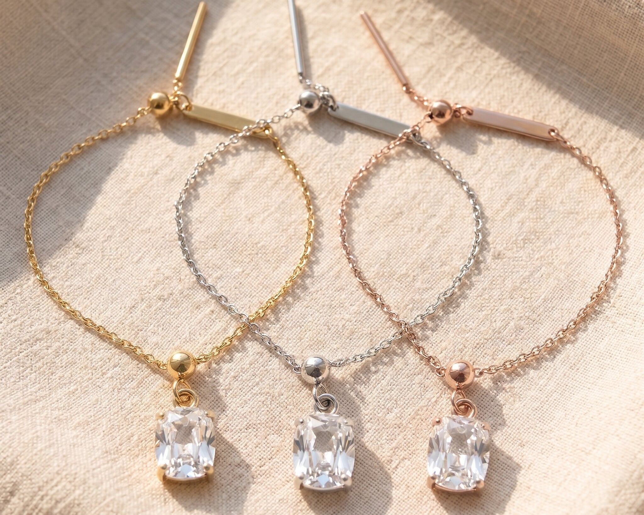 Empowerment bracelet tone comparison showing gold, silver and rose gold finishes with crystal charm