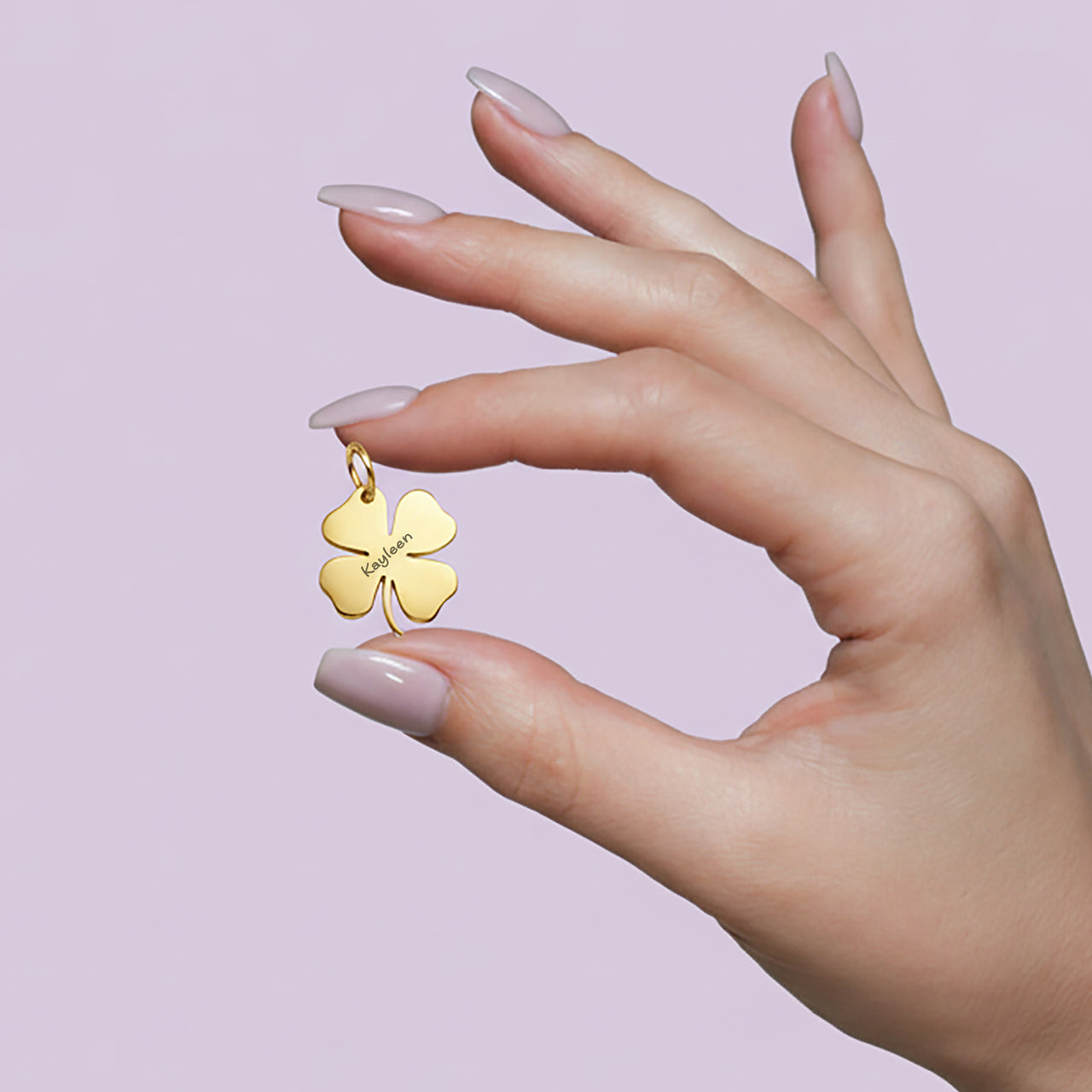 Belle Fever Personalized Four Leaf Clover Keychain Charm on model's hand featuring delicate engraving and smooth metallic shine. A timeless keepsake that carries lucky wishes and heartfelt sentiment, perfect as a custom gift for her.