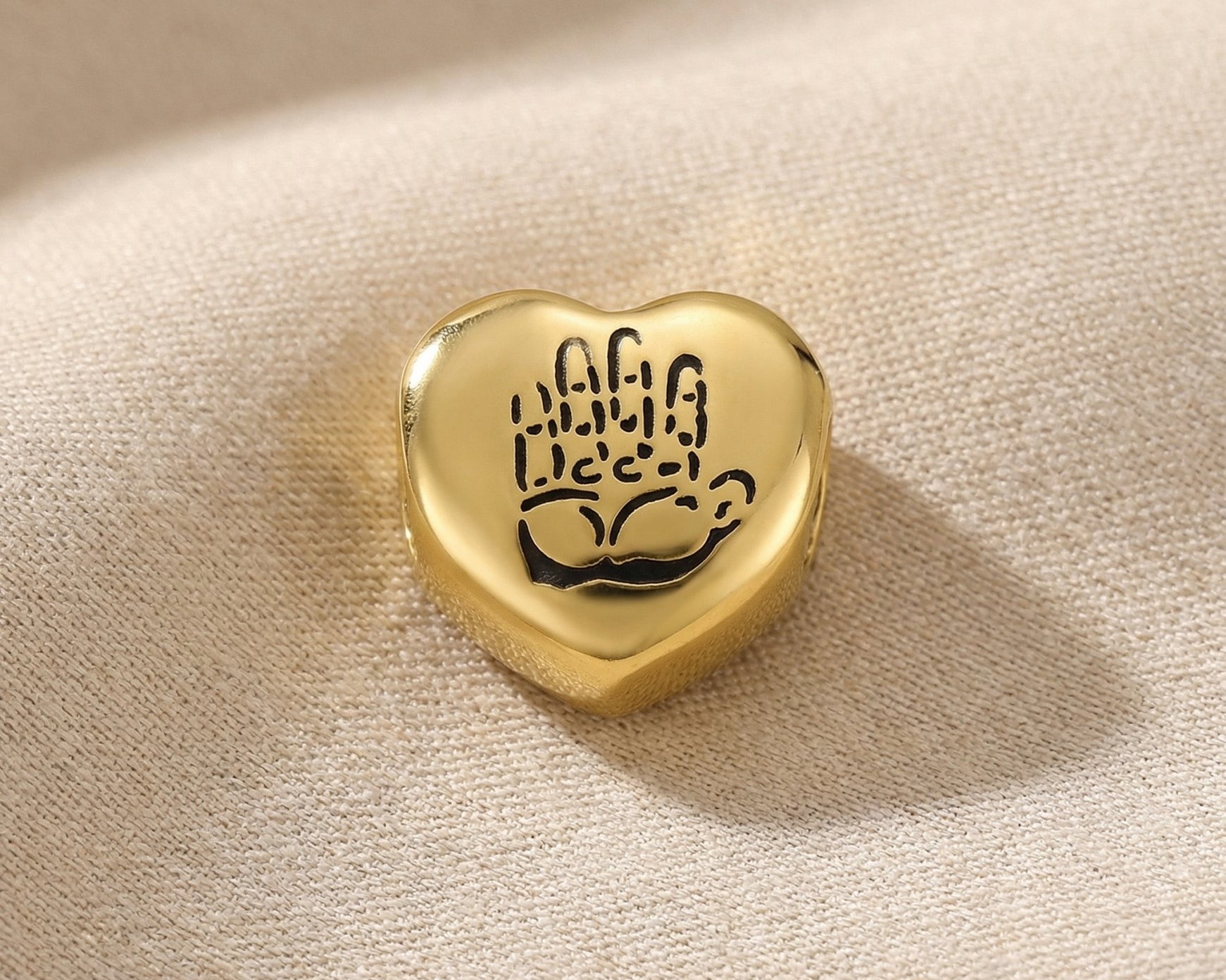 Gold heart charm with hand illustration for Moments Bracelet symbolizing love, loyalty, and connection