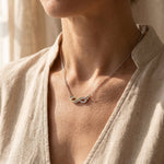 Woman wearing highs and lows necklace, symbolic jewellery representing life journey and connection