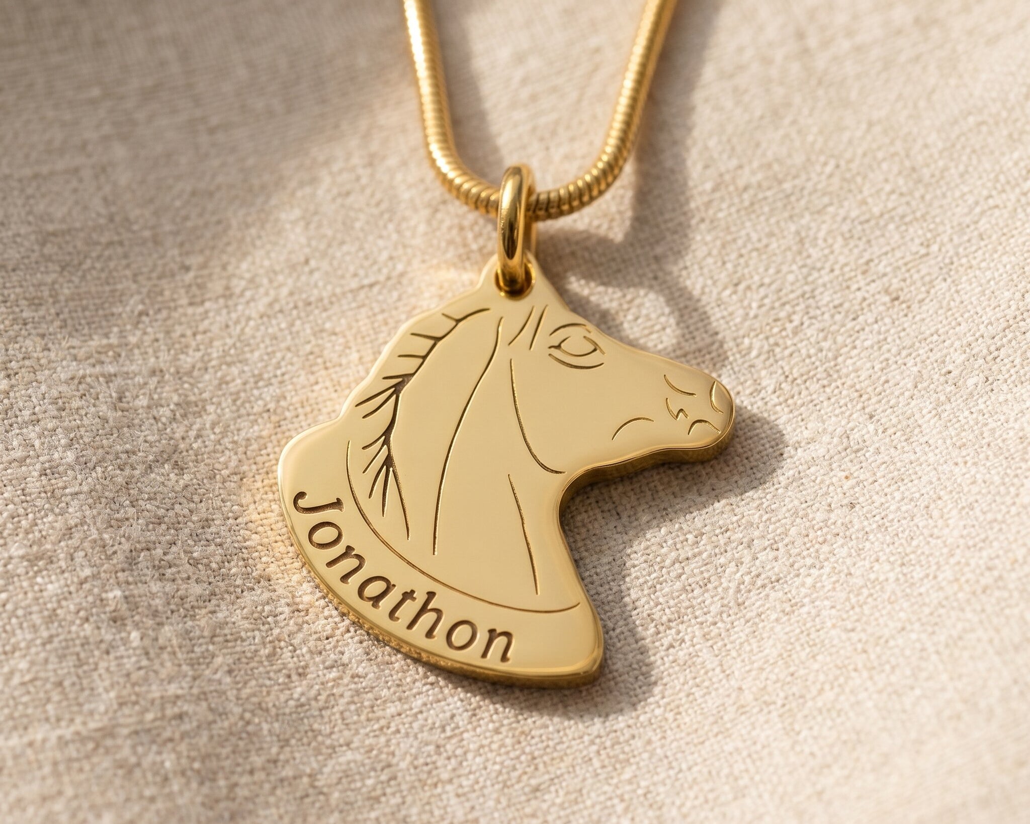 Horse head name necklace in gold with engraved name, elegant personalised jewellery design