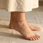 Infinity anklet worn on ankle with delicate chain and infinity symbol design