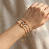 Infinity bracelet worn on wrist with fine chain and infinity symbol detail