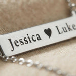Close-up of Jess Bar Necklace showing engraved name and fine polished detail on bar pendant